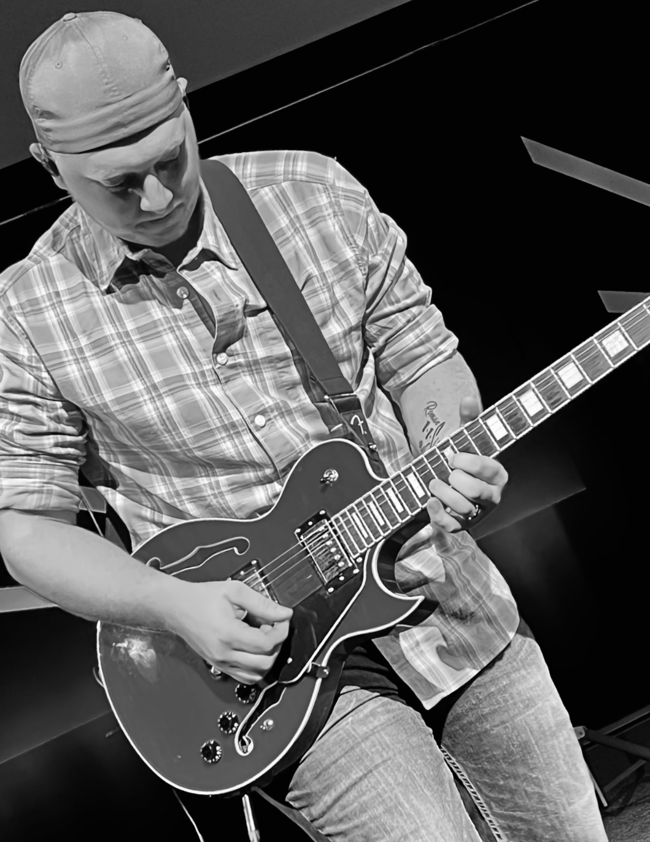 Joshua Dean playing guitar in black and white